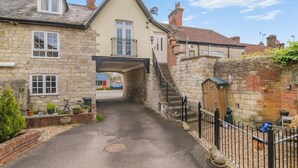 A narrow street with stone buildings, a small bridge, and a gate. - 1 Bed in Queen Camel (oc-c30506) (Queen Camel)