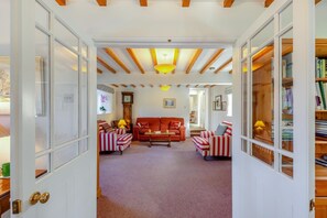 A cozy living room with striped armchairs, a red sofa, and a wooden ceiling. - 4 Bed in Mallerstang (oc-s22487) (Mallerstang)