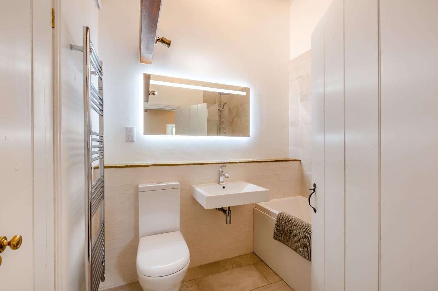 A compact bathroom with a toilet, sink, and bathtub.