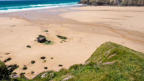 A wide sandy beach with a grassy hill in the background and a clear blue sky. - 3 Bed in Winnards Perch (oc-m30557) (Winnard's Perch)
