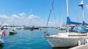A marina with multiple boats docked, calm water, and a clear sky. - 2 Bed in Freshwater (oc-a30347) (Freshwater)