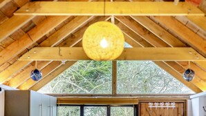 A wooden ceiling with a central hanging light fixture and two smaller lights on either side. - 1 Bed in Swanage (oc-l30493) (Harman's Cross)