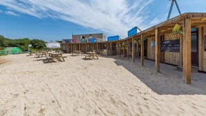 A beachside wooden structure with picnic tables and a sign for a beach cafe. - 6 Bed in Winnards Perch (oc-c30624) (Winnard's Perch)