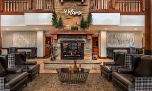 A lobby with a fireplace, two large paintings, and a 'Welcome' sign above it. - Ski Park City, TG wk Nov2026, in luxury 2bdr,2 ba condo, ski-in, ski-out. (Park City)