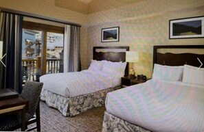 A hotel room with two beds, a desk, and a chair. There is a window with curtains, and a picture is hung on the wall. - Ski Park City, TG wk Nov2026, in luxury 2bdr,2 ba condo, ski-in, ski-out. (Park City)