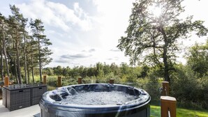 A hot tub surrounded by a deck, with a pool and trees in the background. - 2 Bed in Swarland (oc-c30636) (Swarland)