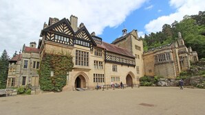 A historic building with a prominent entrance, large windows, and a stone facade. - 5 Bed in Biddlestone (oc-b30105) (Biddlestone)
