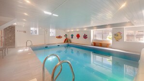 An indoor swimming pool with a clear view of the pool area, a bench, and colorful wall decorations. - 4 Bed in East Allington (oc-k30711) (East Allington)