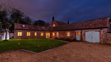 A brick house with multiple windows and a garage.