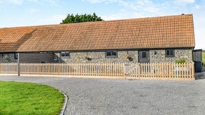 A stone building with a tiled roof and a wooden fence. - 2 Bed in Clevedon (oc-s30785) (Clavedon)