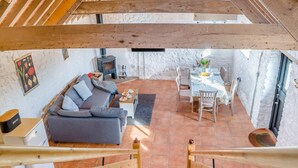 A cozy interior with a sofa, dining table, and a fireplace. - 2 Bed in Clevedon (oc-s30785) (Clavedon)