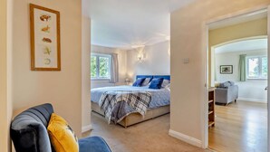 A bedroom with a bed, a chair, and a hallway leading to a living area. - 2 Bed in Hanley William (oc-d30115) (Hanley William)