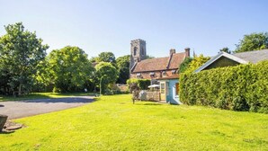 A residential area with a house, a small garden, and a church tower. - 2 Bed in Horsham St. Faith (oc-b30838) (Horsham Saint Faith)