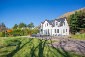 A two-story house with a front porch, surrounded by a well-maintained lawn and trees. - 3 Bed in Letter Finlay (oc-l30952) (Altura)