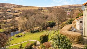 A rural landscape with a river, a flag, and a building with a satellite dish. - 2 Bed in Withypool (oc-c30940) (Withypool)