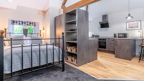 A bedroom with a bed, a nightstand, and a window with curtains. - 1 Bed in Nant-y-derry (oc-g30807) (Nant-y-derry)