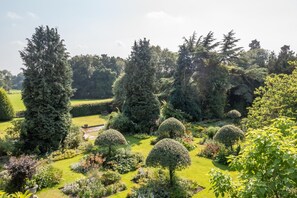 A well-maintained garden with various trees and shrubs, a clear pathway, and a bench. - 1 Bed in Sutton-on-the-Forest (oc-t30950) (Sutton-on-the-Forest)