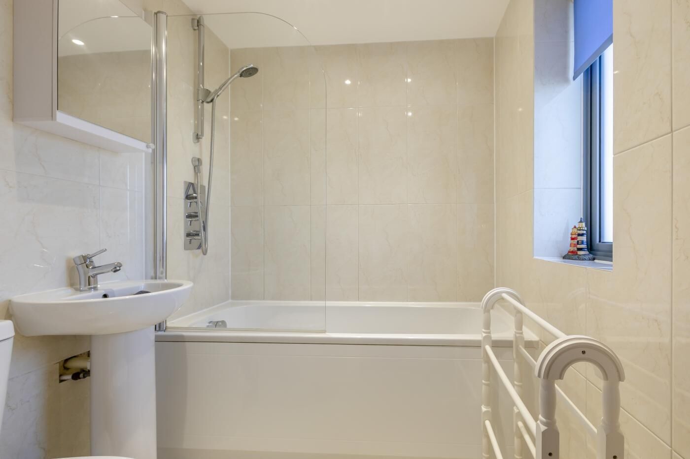 A modern bathroom with a bathtub, a sink, and a shower.