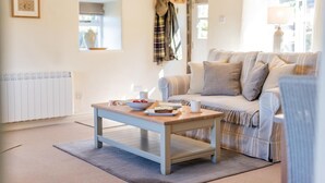 A cozy living room with a sofa, a coffee table, and a radiator. - 1 Bed in Ravenscar (oc-p30830) (Fylingdales)