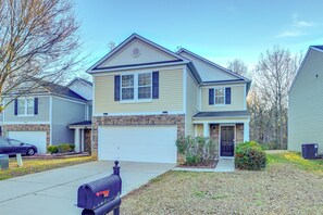 A two-story house with a garage, a front porch, and a mailbox. - 4BR Pet-Friendly Charlotte Home | 6 Mi to CLT (Charlotte)