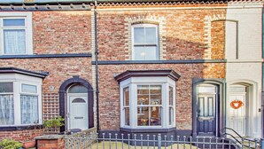A row of terraced houses with bay windows, a brick facade, and a metal fence. - 1 Bed in Whitby (oc-l31011) (Whitby)