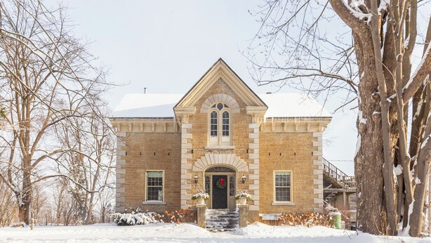 A large, historic building with a prominent entrance, a brick facade, and a snow-covered landscape. - Strathmere Country Retreat (Ottawa)