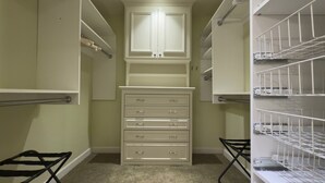 A walk-in closet with open shelving, a mirrored closet door, and a set of drawers. - Desert Oasis backing Golden Hills Golf Course. (Mesa)