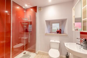 A modern bathroom with a glass-enclosed shower, a white toilet, and a sink with a mirror above it. - 2 Bed in Hawick (oc-p30967) (Hawick)