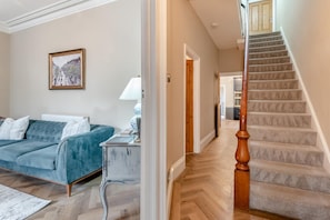 A living room with a sofa, a lamp, and a framed picture on the wall. - 6 Bed in Buxton (oc-s31063) (Buxton)