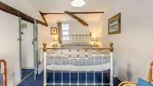 A bedroom with a bed, wooden beams, a window, a picture on the wall, and a chair. - 2 Bed in Windermere (oc-c31666) (Crook)