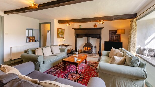 A cozy living room with a fireplace, sofas, and a coffee table. - 3 Bed in Windermere (oc-b31667) (Crook)