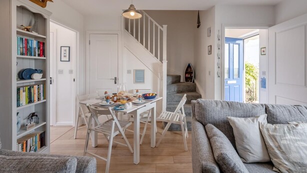 A cozy living room with a dining area, a staircase, and a bookshelf. - 2 Bed in Camber (oc-r31753) (Camber)
