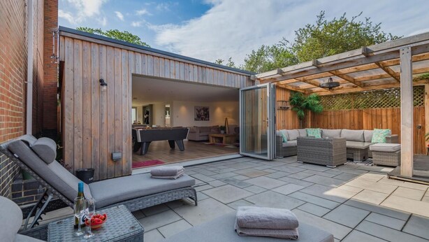 An outdoor patio with a pool table, lounge chairs, and a covered seating area. - 1 Bed in Badgeworth (oc-b31881) (Badgeworth)