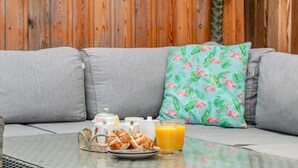A breakfast setup on a glass table with a wooden backdrop. - 1 Bed in Badgeworth (oc-b31881) (Badgeworth)
