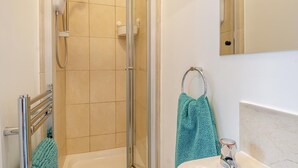 A modern bathroom with a glass-enclosed shower, a bathtub, and a sink with a towel rack. - 1 Bed in Sheringham (oc-n31825) (Sheringham)