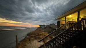 A coastal house with a staircase leading to a porch overlooking the beach. - Surf City Oceanfront -6BR -2.5 Bath -Sleeps 12 -Direct Beach Access (Surf City)