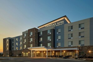 A multi-story hotel with a stone facade, a covered entrance, and a sign reading 'Towneplace Suites by Marriott.' - Towneplace Suites By Marriott Romeoville (Romeoville)