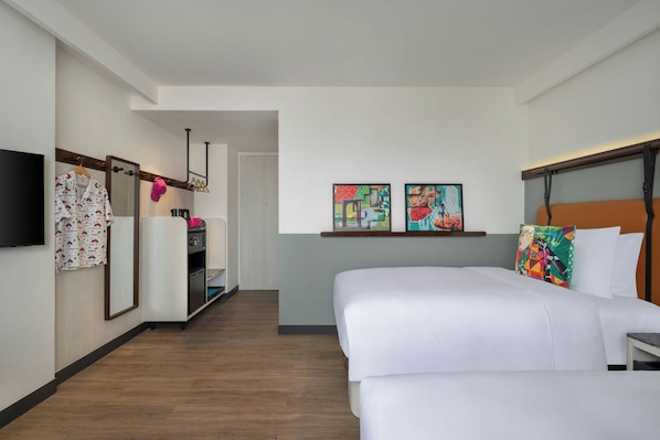 A hotel room with a double bed, a TV, a wardrobe, and a small desk. - Moxy Kathmandu (Kathmandu)