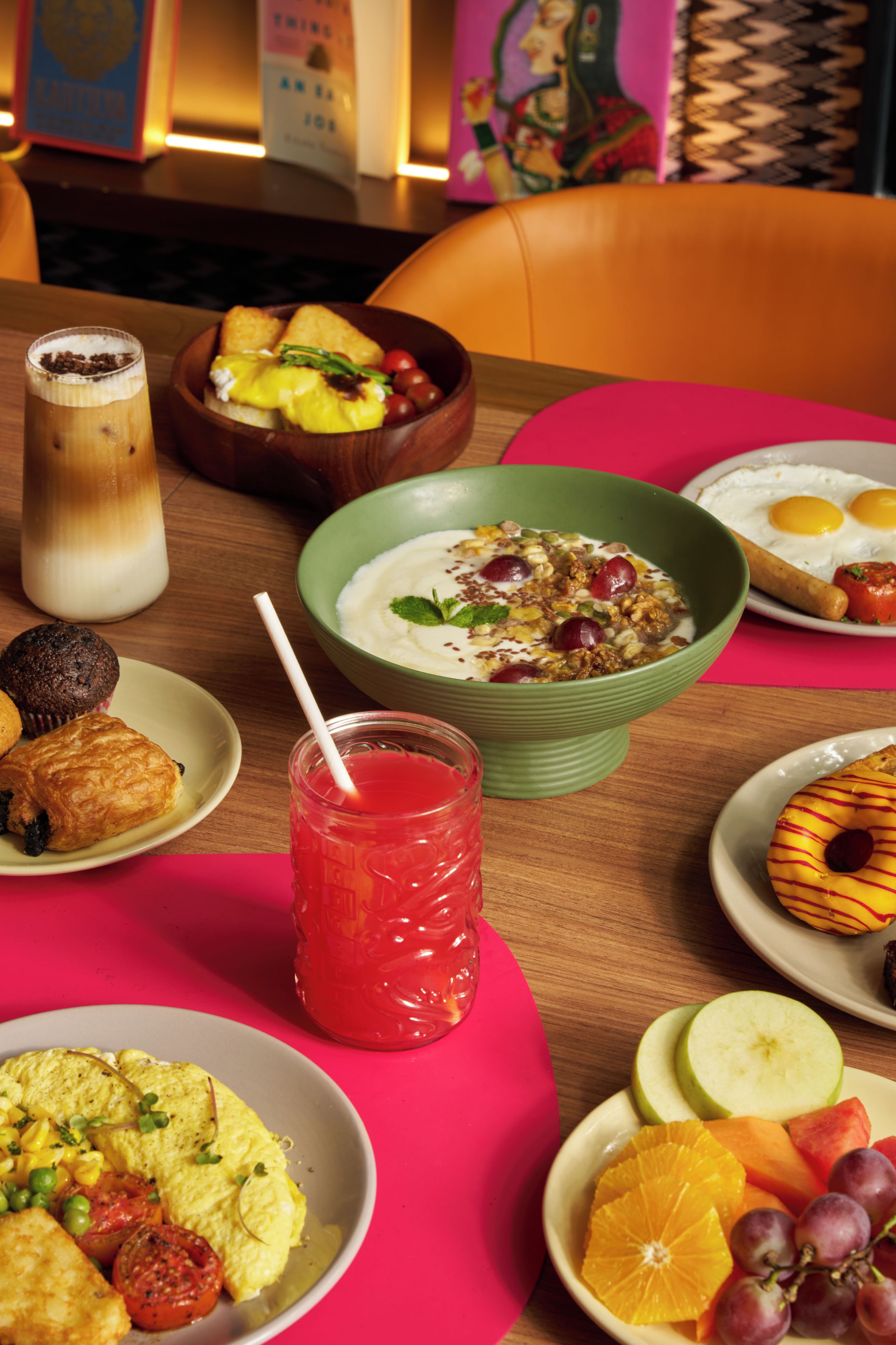 A dining table with various breakfast items including eggs, toast, and a bowl of cereal.