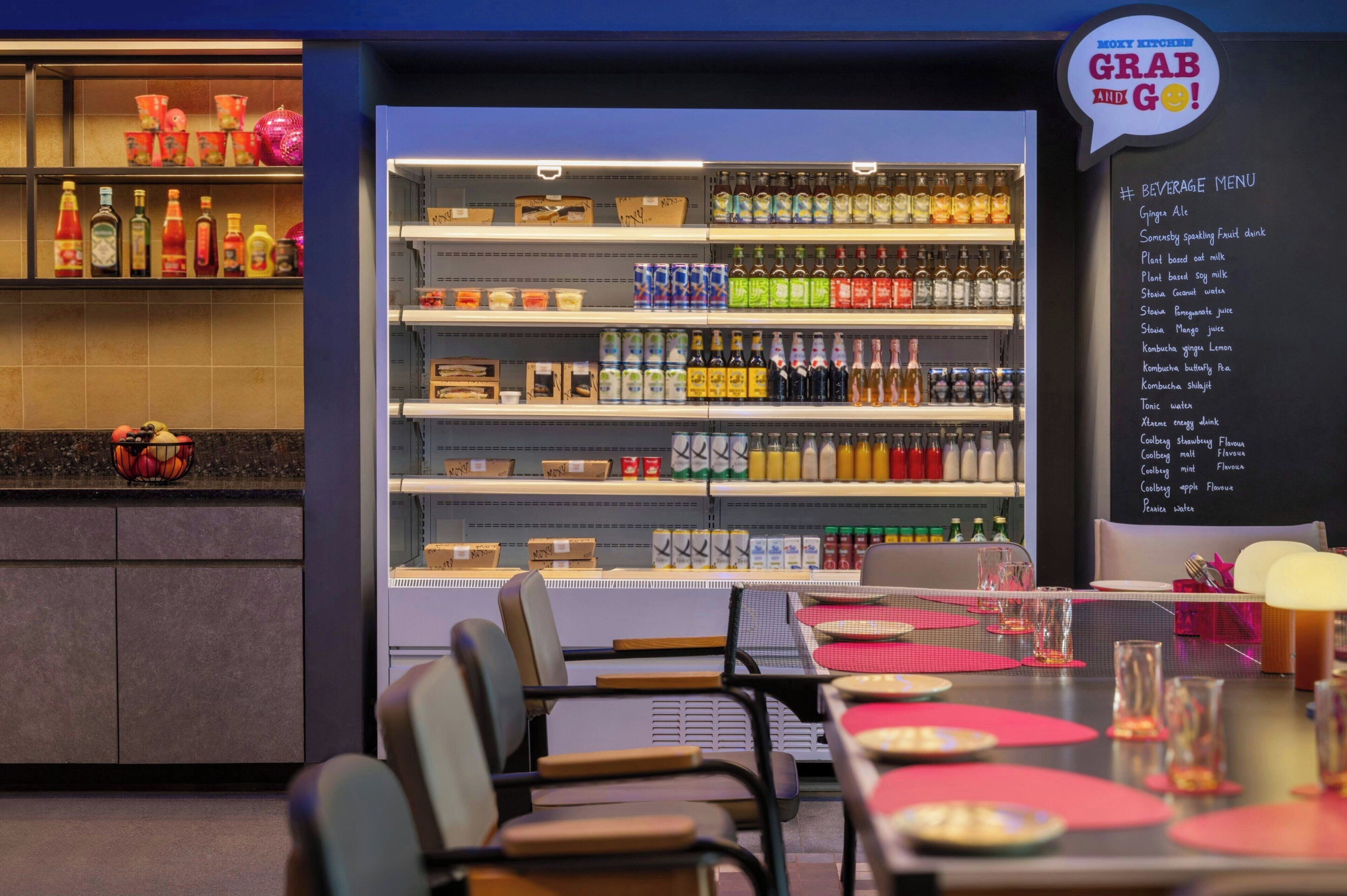 A restaurant interior with a beverage menu, shelves stocked with bottles, and tables set for dining.
