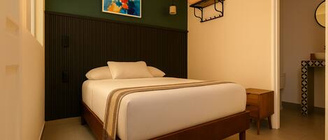 A modern bedroom with a wooden bed, a bedside table, a wall-mounted shelf, and a painting.