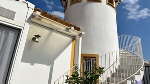 A white building with a cylindrical tower, a staircase, and a window. - Luxury Villa with Private Pool in a Quiet Setting (Mazarrón)