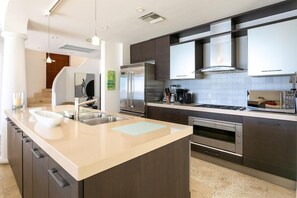 A modern kitchen with a central island, stainless steel appliances, and a large window. - Farniente   Shore Pointe villa with Ocean Views (Saint Martin)