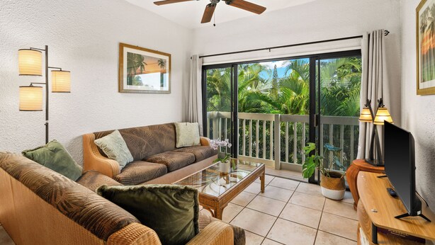 A living room with a sofa, coffee table, and a ceiling fan. - Tropical Getaway North Shore Princeville Studio (Princeville)