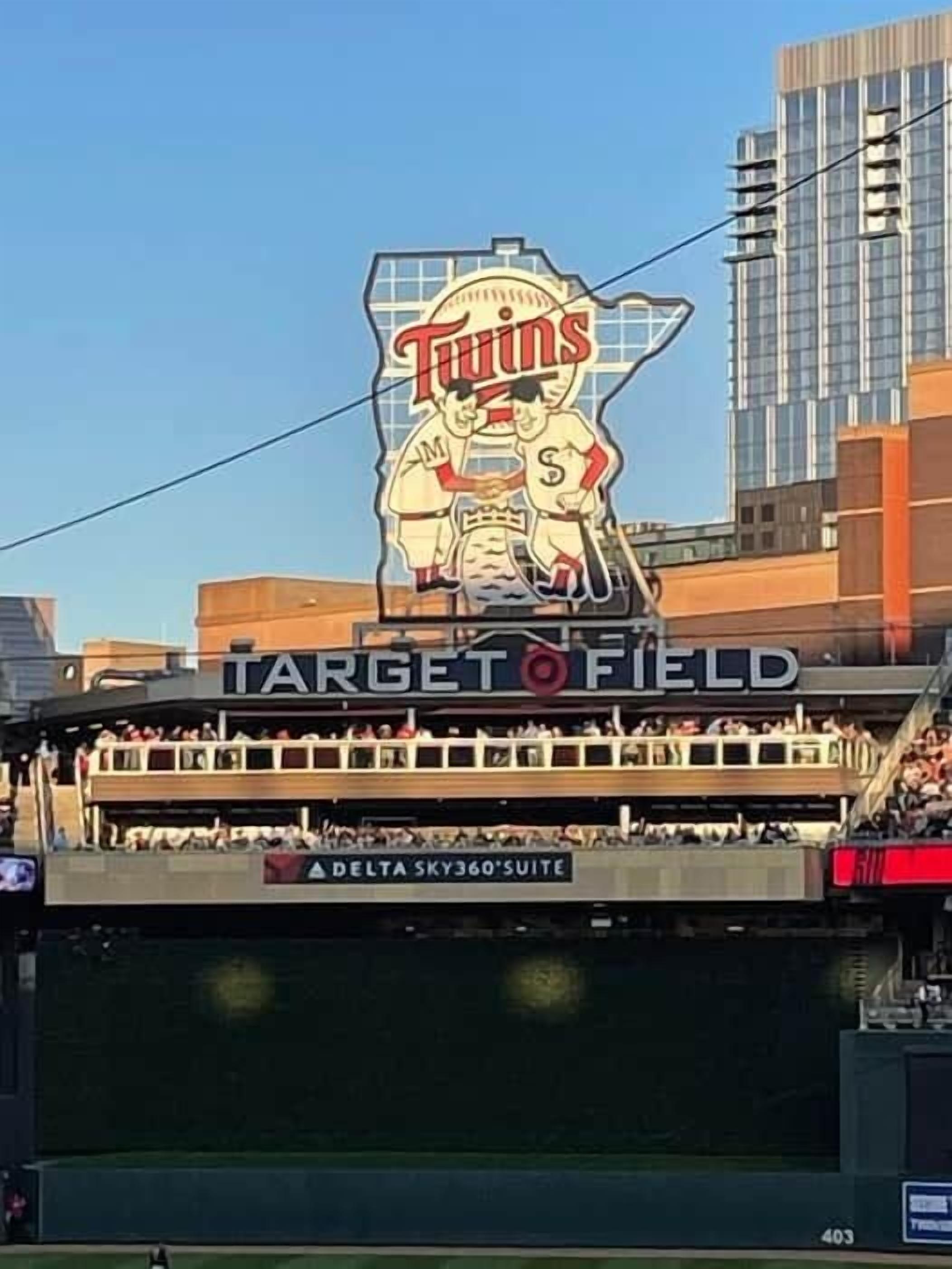 A stadium with a large 'Minnesota Twins' logo, 'Target Field' signage, and 'Delta Sky360 Suite' advertising.