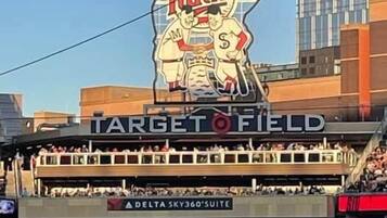 A stadium with a large 'Minnesota Twins' logo, 'Target Field' signage, and 'Delta Sky360 Suite' advertising.