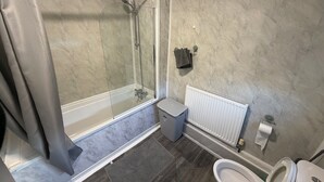 A modern bathroom with a glass-enclosed shower, a toilet, and a radiator. - 3 bedroom flat close to city centre Newcastle upon Tyne (Newcastle upon Tyne)