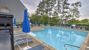 A swimming pool with lounge chairs and umbrellas, surrounded by trees. - Steps to the pool 10 min to Bethany Beach, Water Views Kayaks & Free Activities Inc Golf @ Bear Trap (Millville)