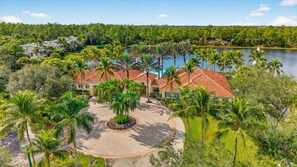 Ein Resort mit Innenhof, Palmen und Seeblick.