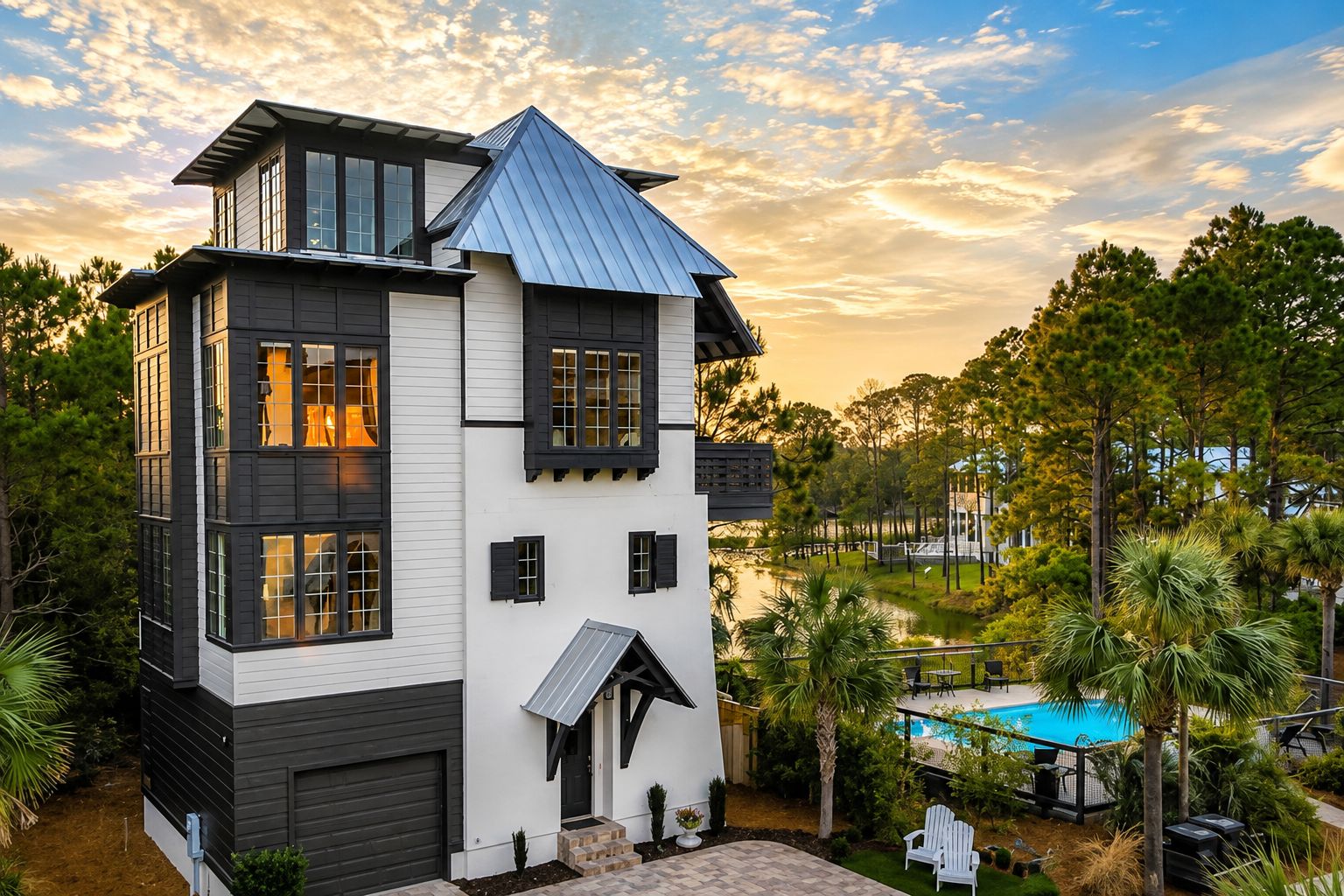 A two-story house with a large deck and a swimming pool.